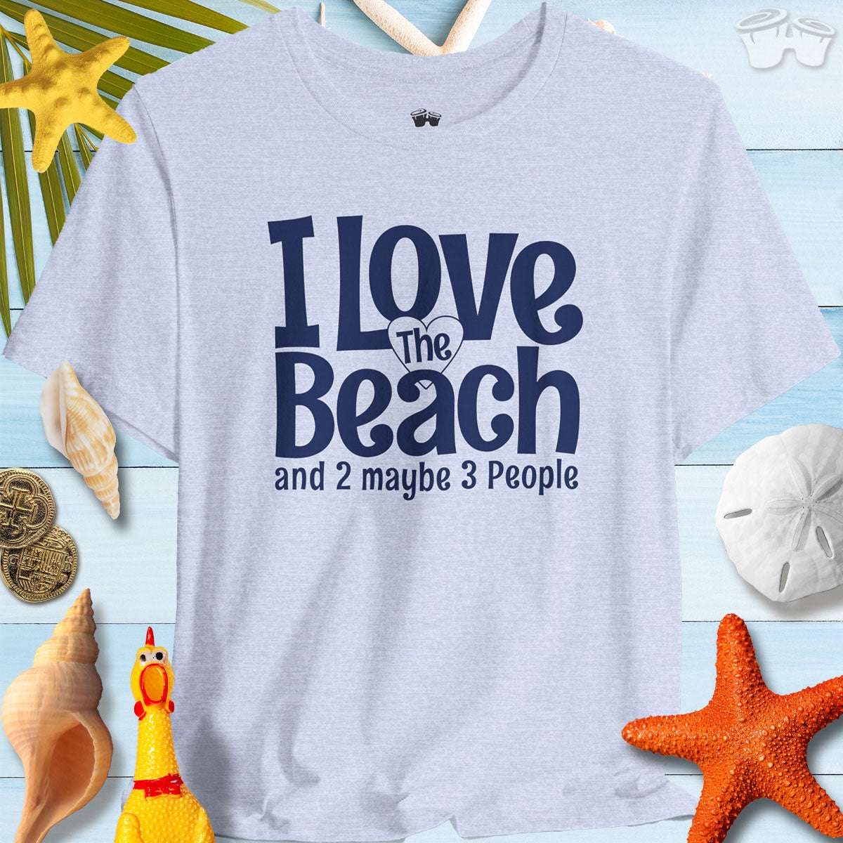 I Love The Beach clever t-shirt displayed on a beach-themed background, perfect for beach lovers and social butterflies.