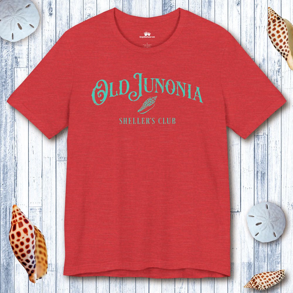 Red t-shirt with 'Old Junonia' text on a wooden surface with shells.