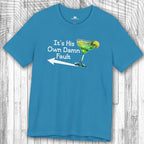 Blue t-shirt with a graphic of a margarita glass and the text:  "It's His Own Damn Fault" margarita party tee on a wooden surface