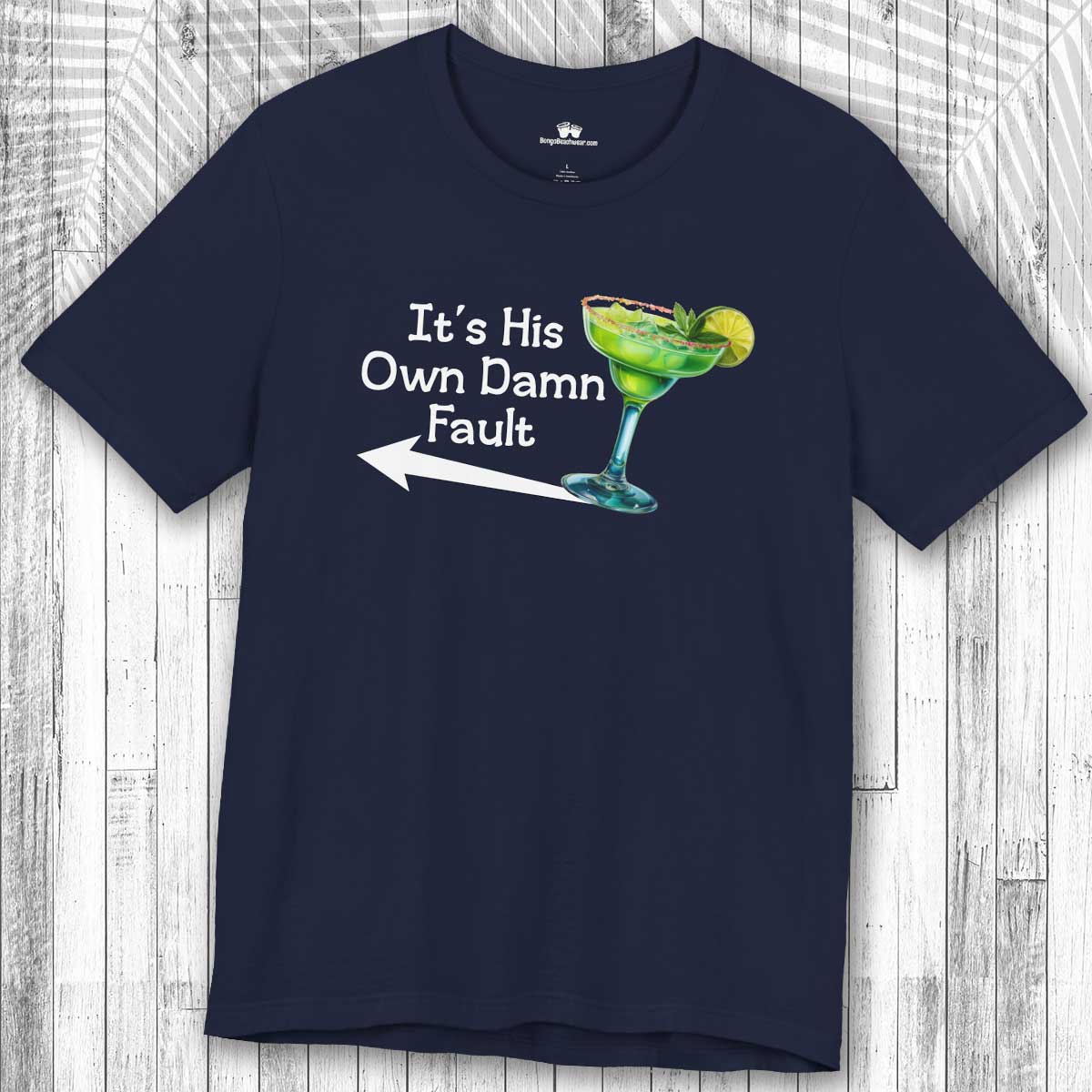 Navy blue t-shirt with a graphic of a Margarita  and text "It's His Own Damn Fault" on a wooden surface