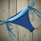 String Bikini Bottoms inside out on wood flor