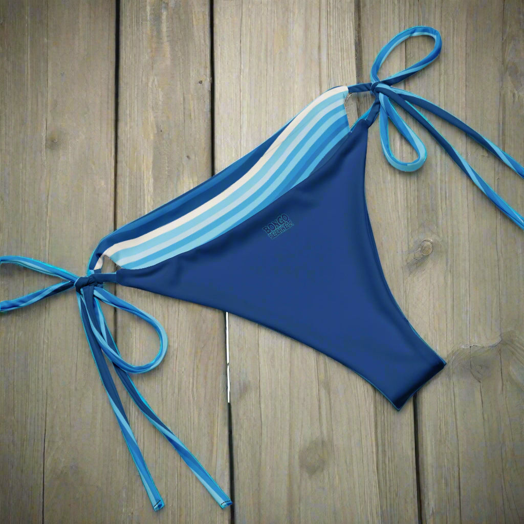 String Bikini Bottoms inside out on wood flor
