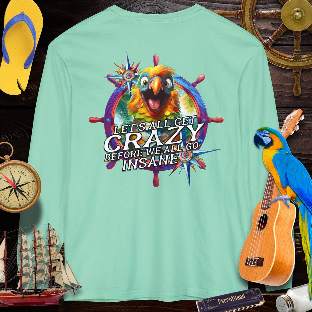 Mint green t-shirt with a colorful parrot graphic and text, surrounded by tropical-themed items.