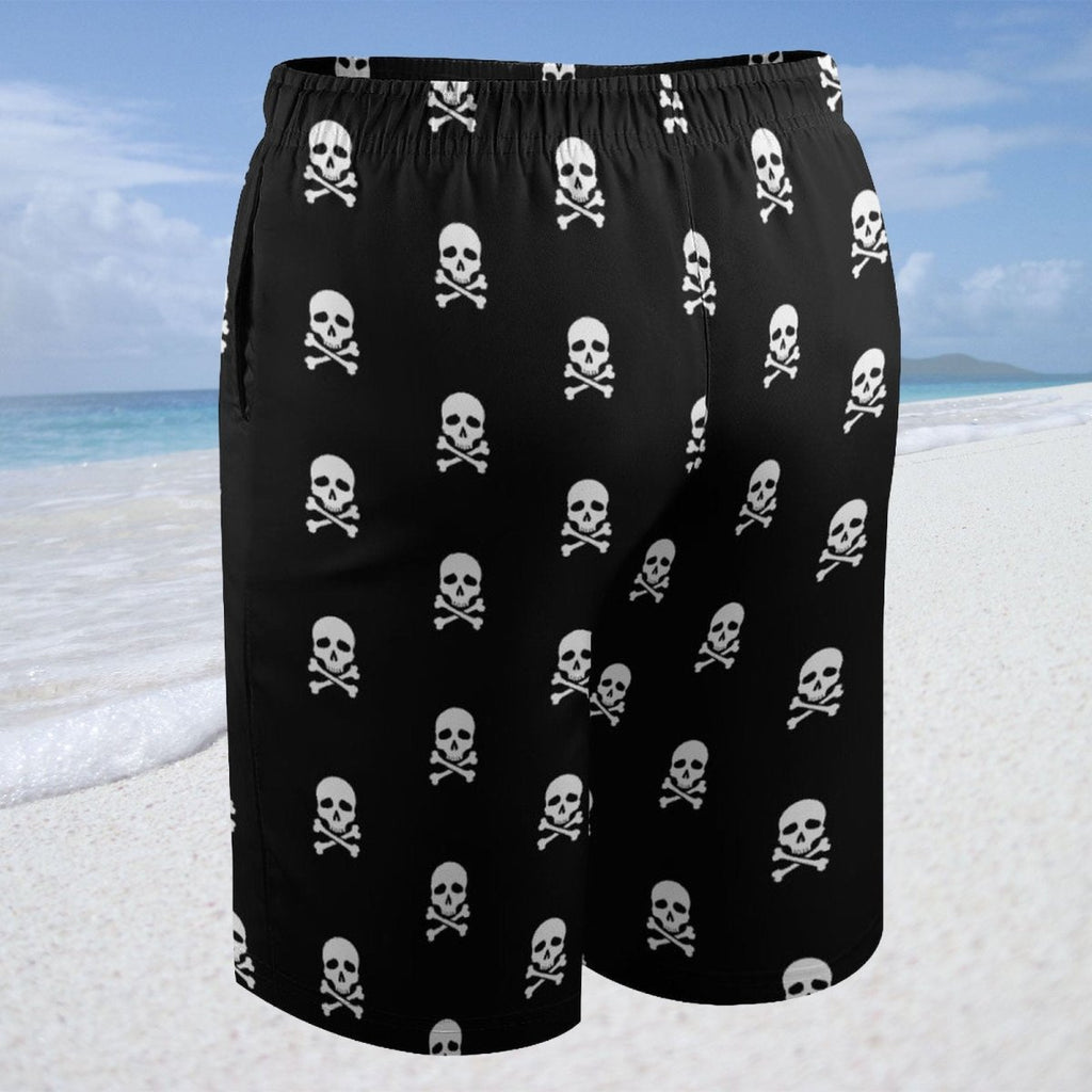 Black shorts with skull and crossbones pattern on a beach