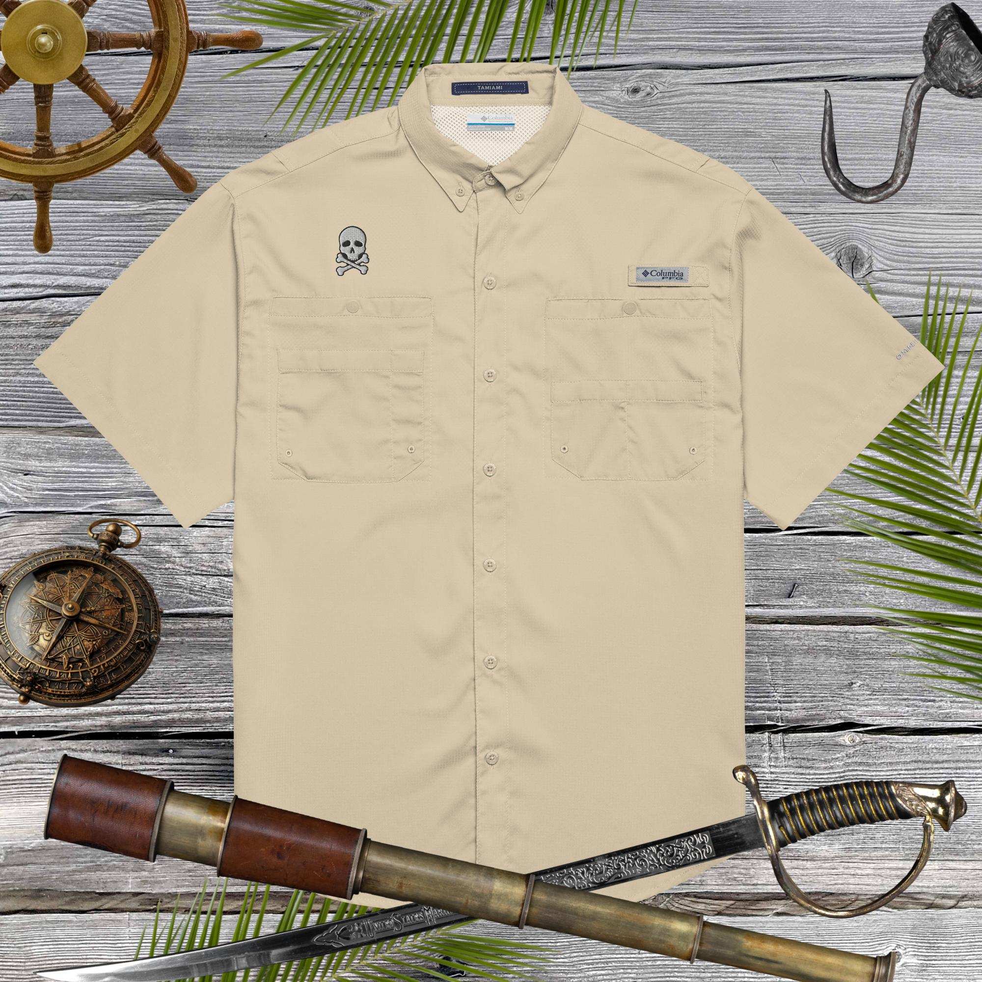 Beige shirt with Jolly Roger Pirate skull embroidery on a wooden background with ship wheel, compass, and sword.