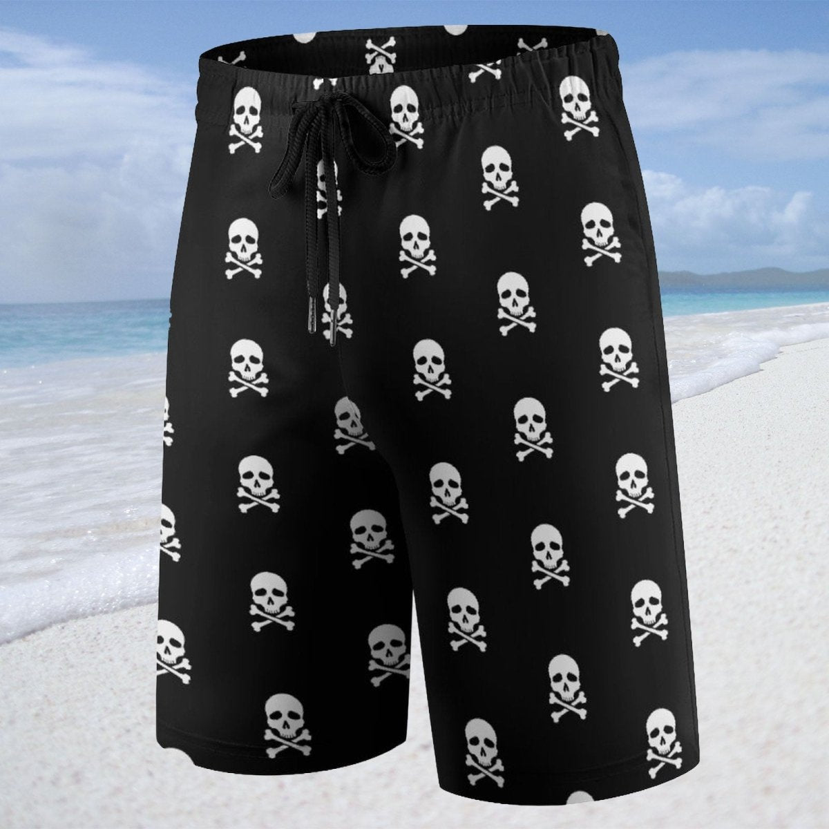 Black shorts with skull and crossbones pattern on a beach