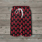 Black shorts with red skull and crossbones pattern on a nautical wood background