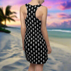 Swimwear model looking for pirate booty along the shores of fashion island in black tank dress covered in pirate skulls