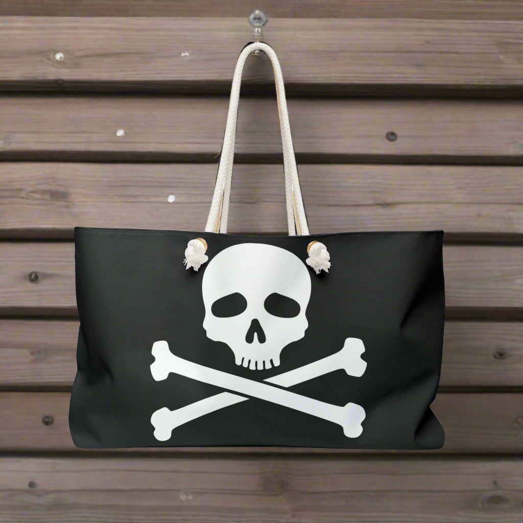 A Jolly Roger Skull and Crossbones Pirate flag Tote Bag hanging on a hook on the bulkhead of a pirate ship
