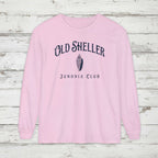 Pink long-sleeve shirt with 'Old Sheller Junonia Club' text and shell graphic on a white background