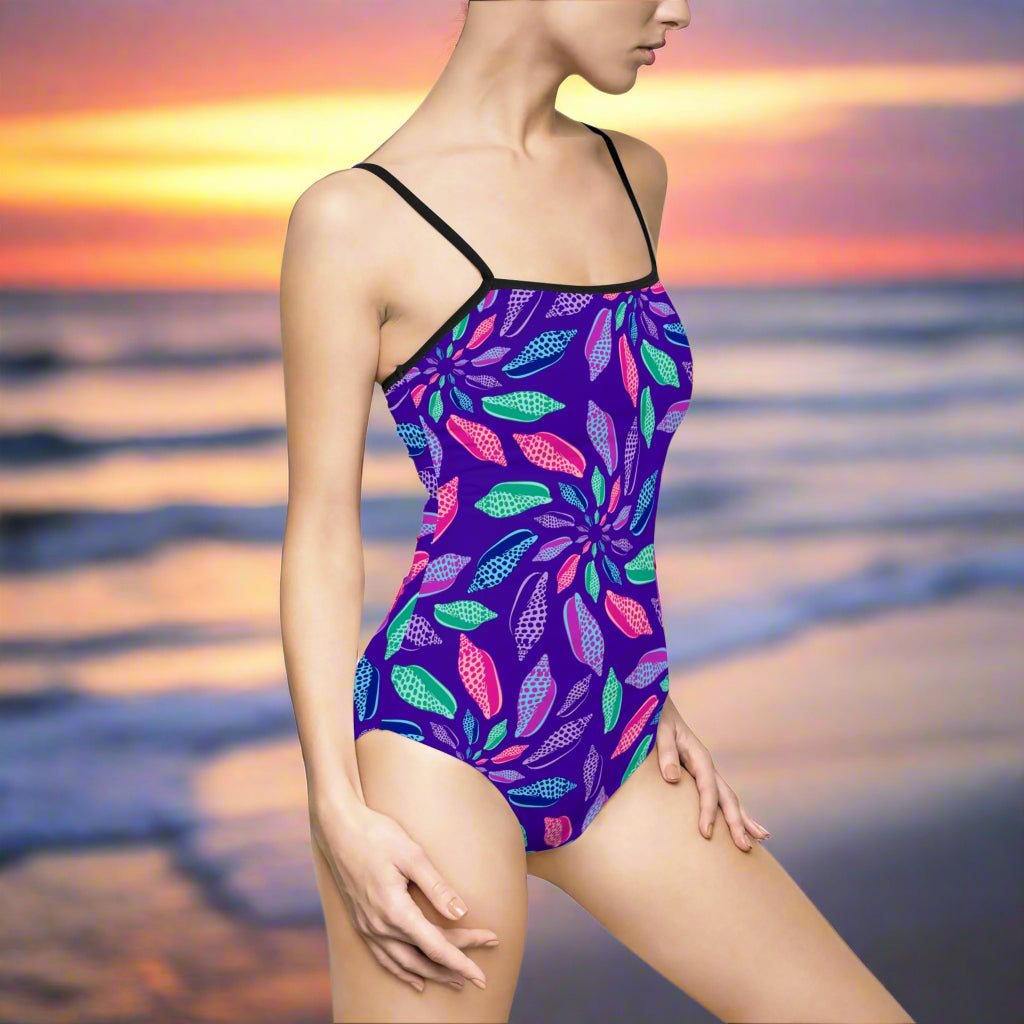 Woman in stunning junonia pattern speghitti strap onesie stand on the beach at sunset