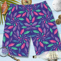 Men's Boardshorts with brightly colored junonia shells in a floral pattern lying on old nautical wood surrounded by compass, a sand dollar, 2 gold coins, a ship in a bottle, a magnifying glass and a Junonia seashell