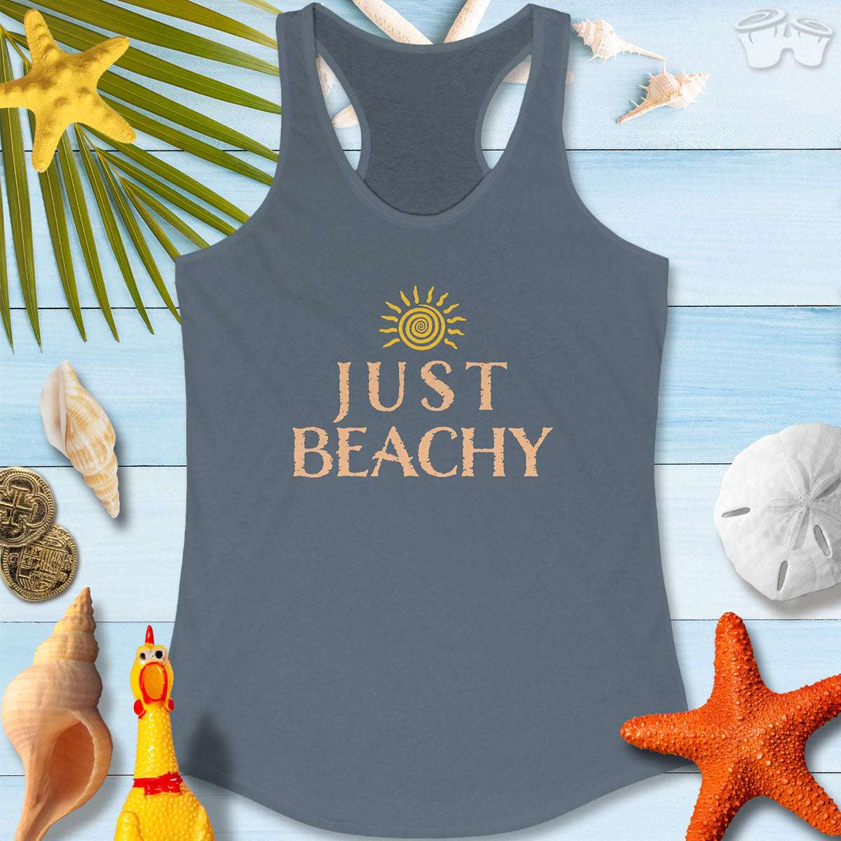 Just Beachy Women's Tank Top laid out with beach decor, featuring a sunny design and a relaxed vibe perfect for summer.