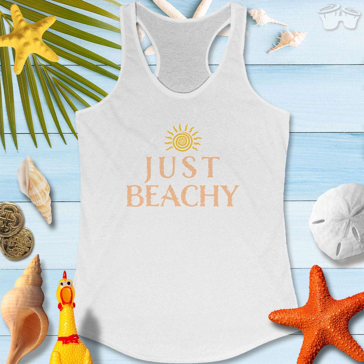 Just Beachy Women's Tank Top on a beachy background with seashells and tropical elements, perfect for summer vibes.