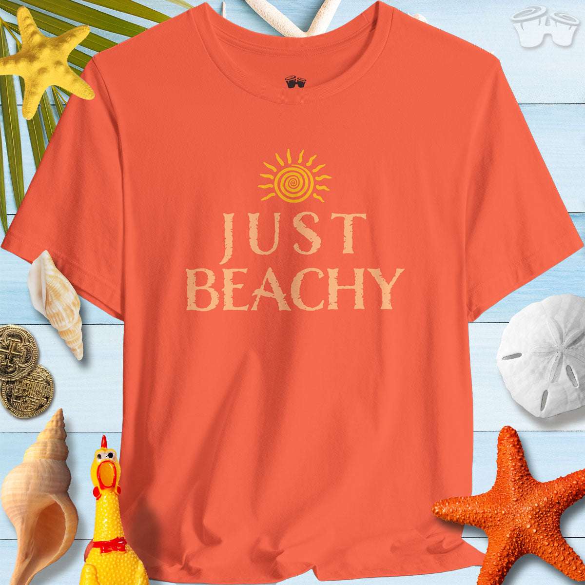 Just Beachy Bella T-Shirt in Tropical Colors displayed with seashells, a sun graphic, and beachy decor for summer vibes.