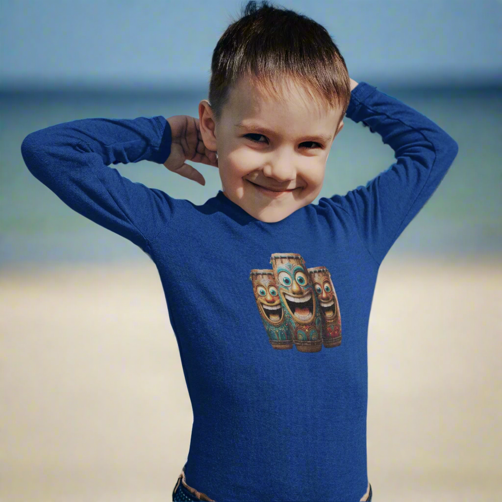 Child wearing a royal blue shirt with laughing tiki bongos design on the beach