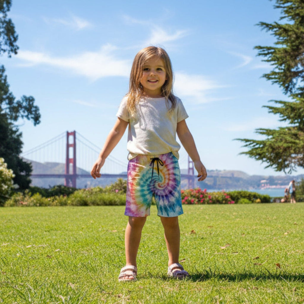 Child standing on grass with the Golden Gate Bridge in the background