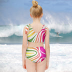 Young girl looking out at the ocean as a surfer reserves a little time in the green room.