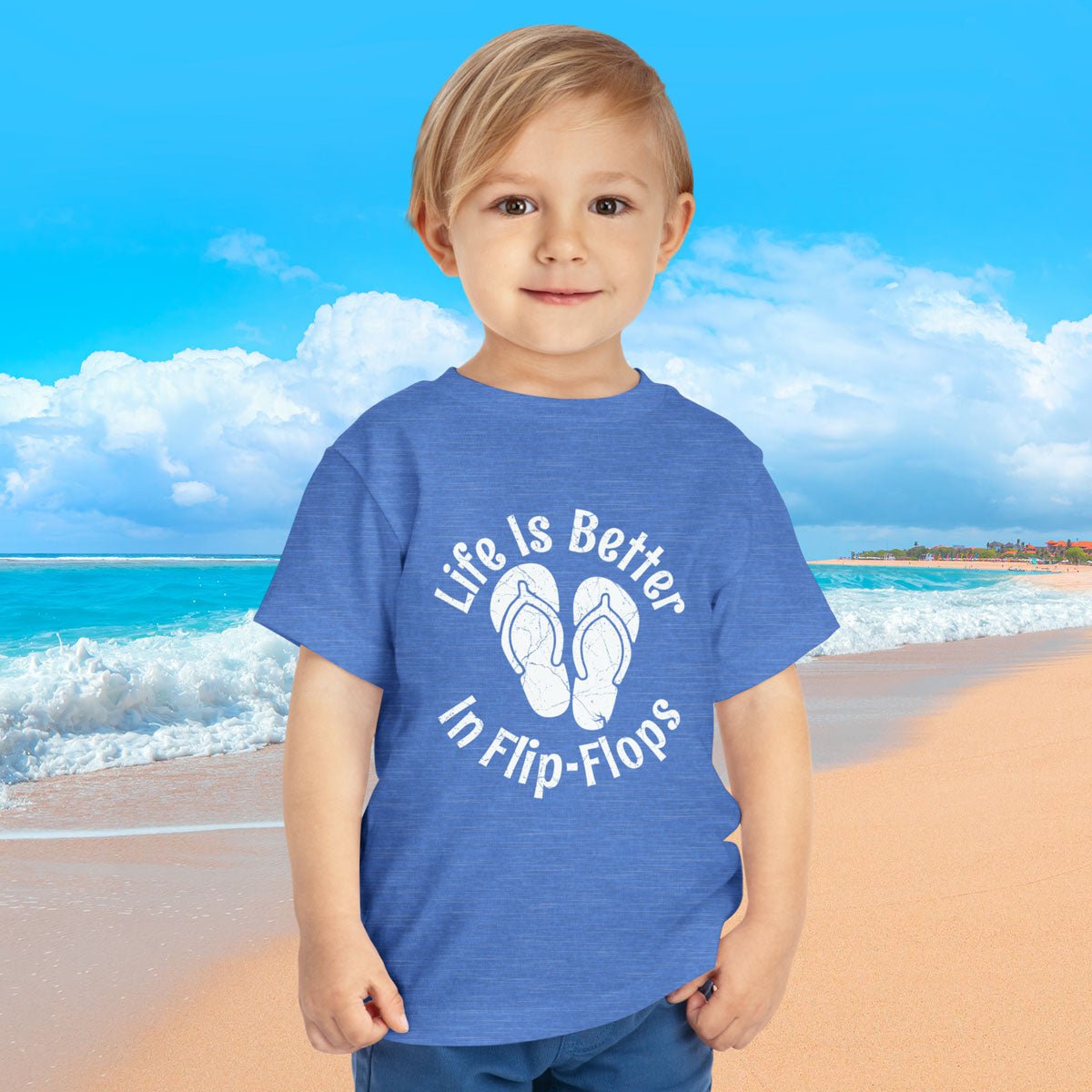 Child wearing a blue t-shirt with 'Life is Better in Flip-Flops' text on a beach background