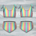 Pastel striped bikini set with bow details on a rustic nautical wood background