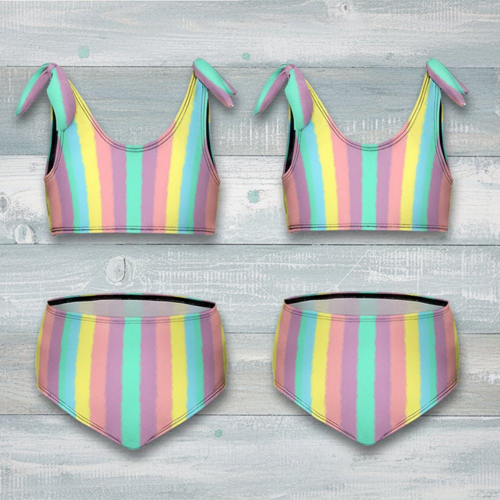 Pastel striped bikini set with bow details on a rustic nautical wood background