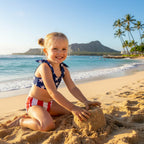 Cute little girl, wearing a Kids American Flag Bikini, building a sand castle on a Hawaiian Island beach