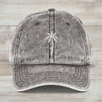 Gray denim cap with embroidered palm tree on a rustic wood background
