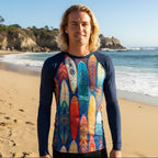Surfer Dude wearing a long-sleeve rashie with colorful surfboard design on the beach in La Jolla Cove