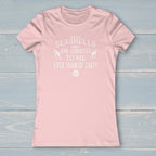 Pink t-shirt with a white logo and text on a nautical wood background