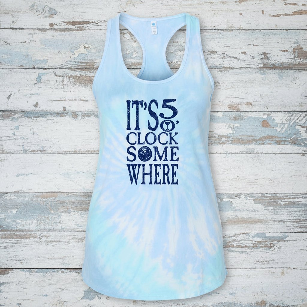 A light blue and white tie-dye racerback tank top with a dark blue graphic text print reading 'IT'S 5 CLOCK SOME WHERE' on the front, shown against a plain white background.