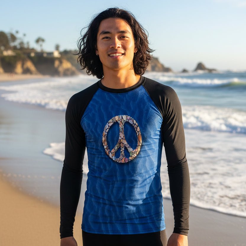 Dude wearing a blue and black sun rashie with a peace symbol on Laguna beach