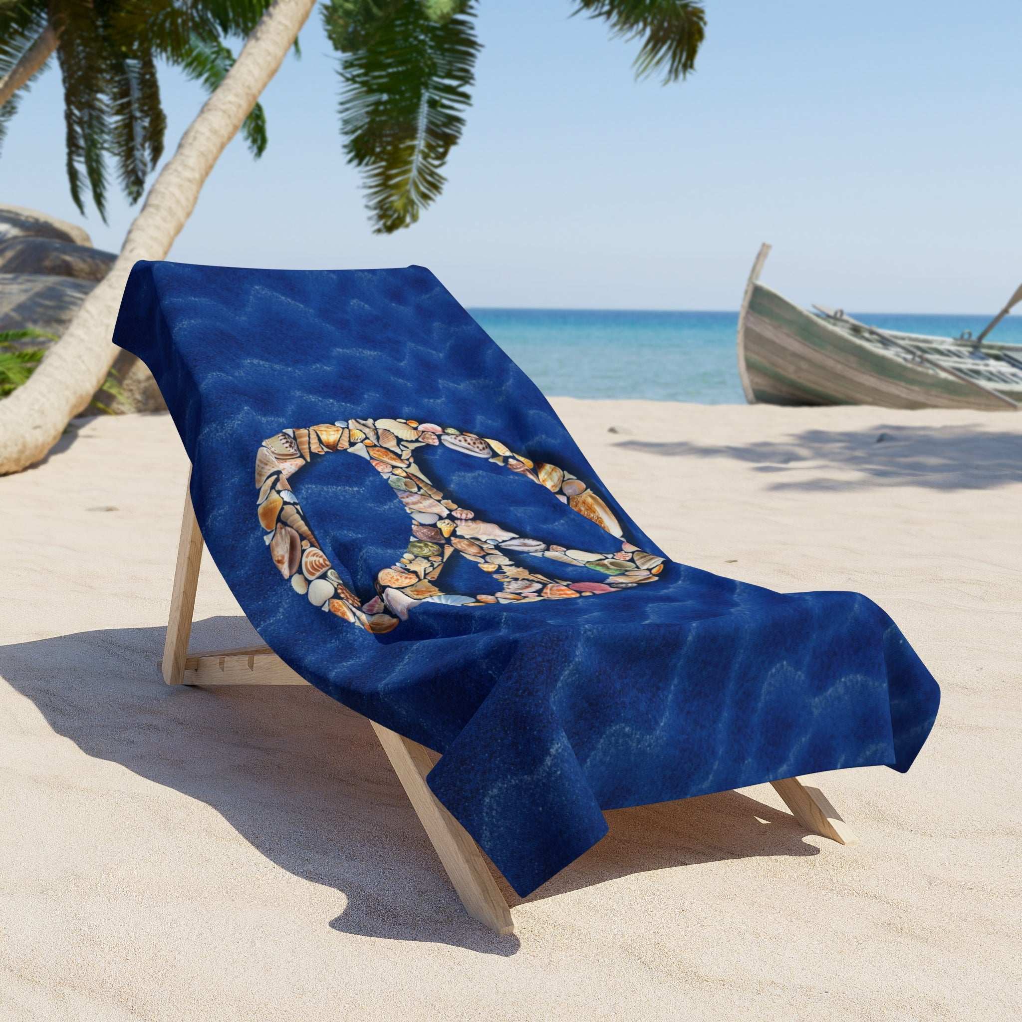 large beach towel laid across a chair on the beach under a palm tree