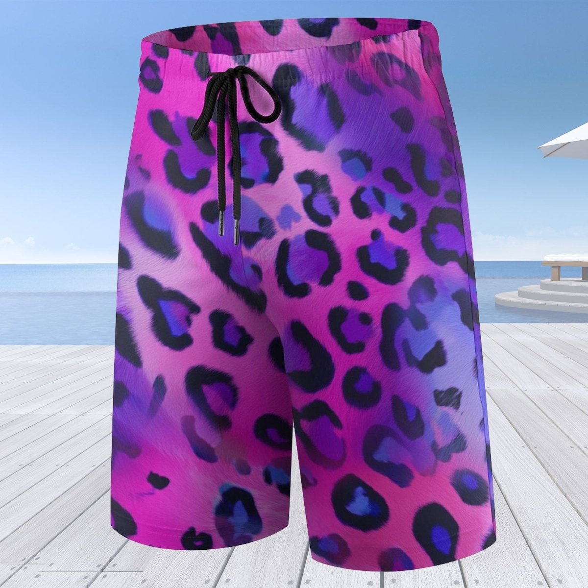 Pink and purple leopard print shorts on a wooden deck with a beach background