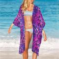 Woman on a Beach Cover Up wearing a purple leopard print cover-up and blue bikini.