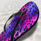 Flip-flop with purple and pink leopard print on a sand textured background