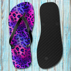Flip-flop with purple and pink leopard print on a wooden surface