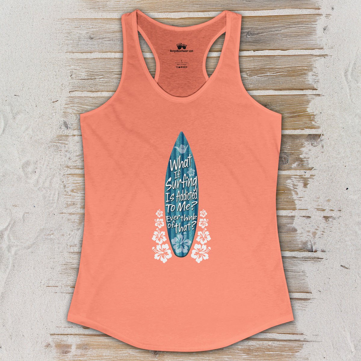 Coral tank top with a graphic design on a wooden surface