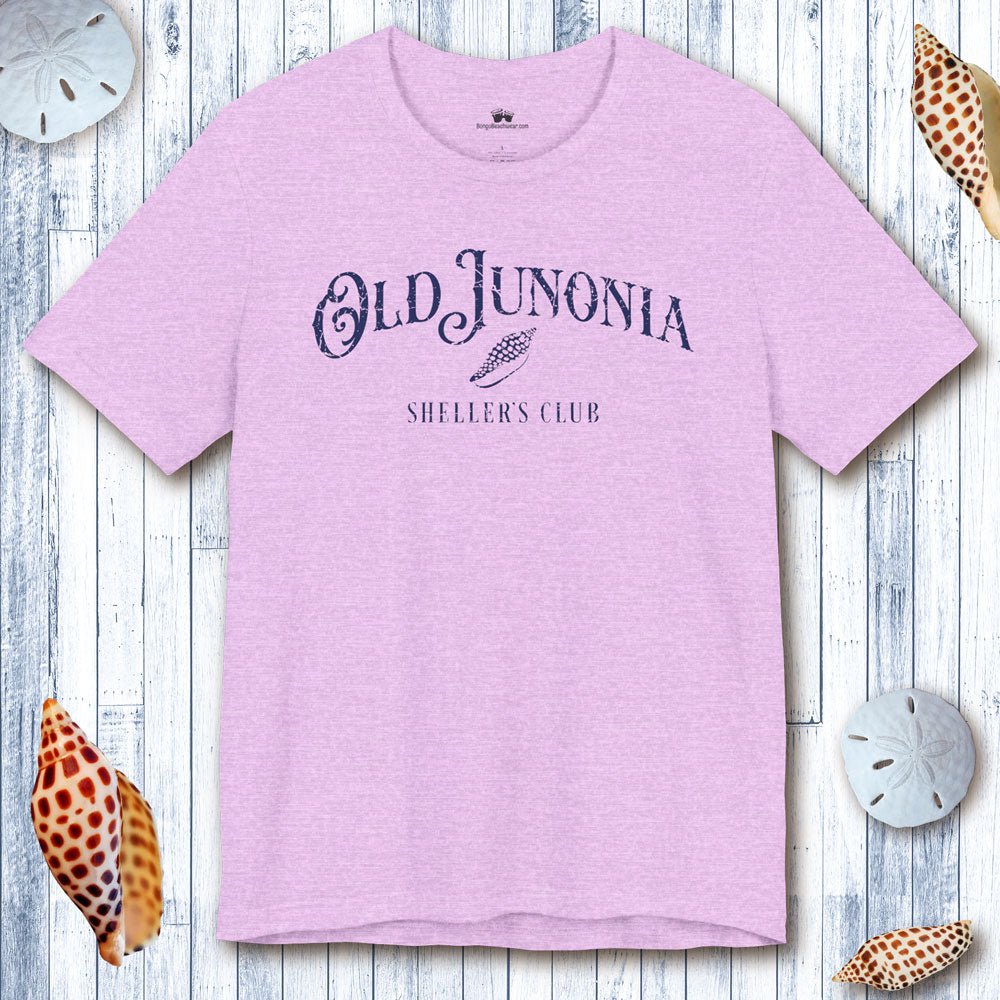 Pink t-shirt with 'Old Junonia' text on a wooden surface with shells.