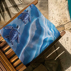 Baby Sea Turtle beach towel folded up on a wooden deck chair next to the swimming pool