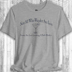 Gray t-shirt with humorous text and graphic on a wooden background