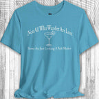 Blue Parrot Head Adventure Shirt  with humorous text and cocktail graphic on a wooden surface