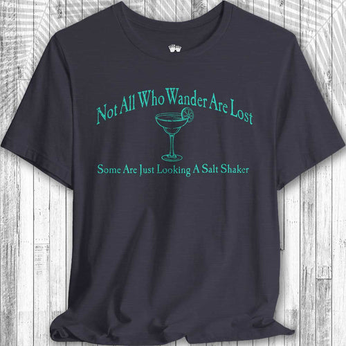 Navy blue Parrot Head Adventure Shirt with green text and a martini glass graphic on a wooden surface