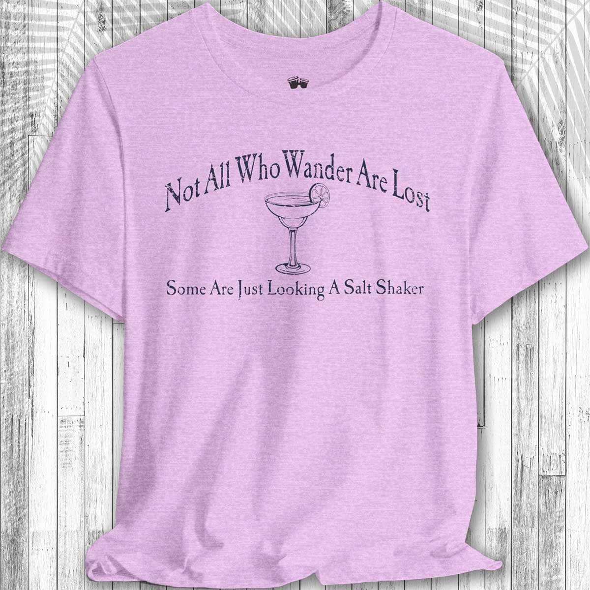 Purple Parrot Head Adventure Shirt with humorous text and graphic on a wooden surface