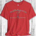 Red Parrot Head Adventure Shirt with humorous text and graphic on a wooden surface