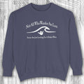 Navy blue shaka inspired sweatshirt with white text and graphic on a wooden background