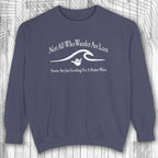 Navy blue shaka inspired sweatshirt with white text and graphic on a wooden background