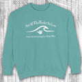 Teal shaka inspired sweatshirt with white text and graphic on a wooden surface