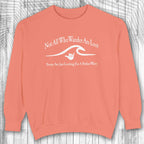 Coral shaka inspired sweatshirt with white text and graphic on a wooden background