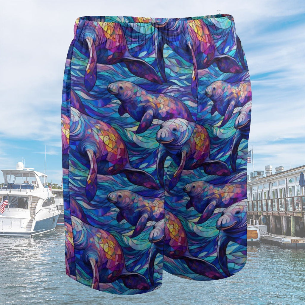 Colorful swim shorts with manatee design against a water and sky background