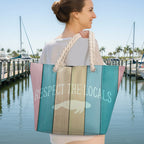 Woman holding a colorful tote bag with 'Respect the Locals' text in West Florida marina. 